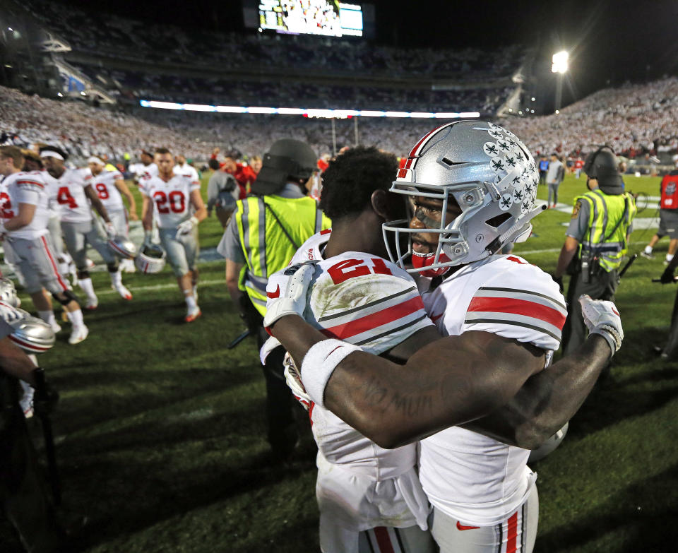Ohio State's Paris Campbell (21), and Johnnie Dixon (1) embrace after beating Penn State 27-26 in an NCAA college football game in State College, Pa., Saturday, Sept. 29, 2018. (AP Photo/Chris Knight)