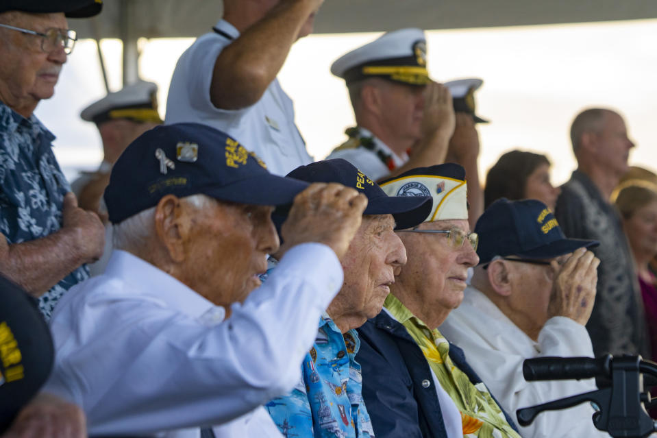 Pearl Harbor survivors Harry Chandler, from left, Ken Stevens, Herb Elfring and Ira "Ike" Schab salute while the national anthem is played during the 82nd Pearl Harbor Remembrance Day ceremony on Thursday, Dec. 7, 2023, at Pearl Harbor in Honolulu, Hawaii. (AP Photo/Mengshin Lin)