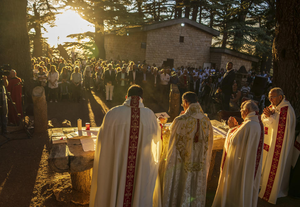 Lebanese Maronite Christian Patriarch Beshara al-Rai, second left, leads the sermon to commemorate the Feast of the Transfiguration in the Cedars of God forest, in the northeast mountain town of Bcharre, Lebanon, Saturday, Aug. 5, 2023. For Lebanon's Christians, the cedars are sacred, these tough evergreen trees that survive the mountain's harsh snowy winters. They point out with pride that Lebanon's cedars are mentioned 103 times in the Bible. (AP Photo/Hassan Ammar)