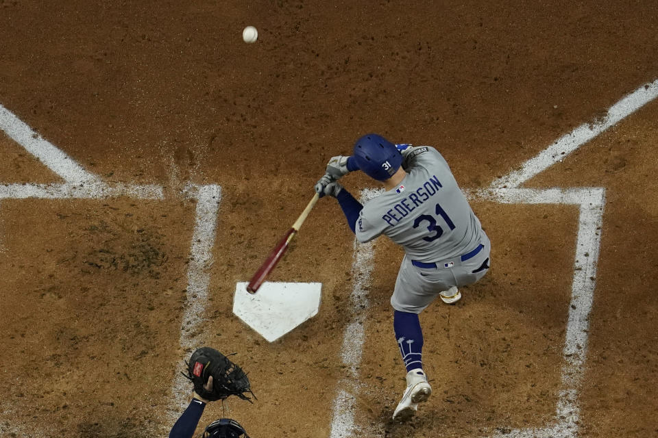 Los Angeles Dodgers' Joc Pederson hits a home run against the Tampa Bay Rays during the first inning in Game 5 of the baseball World Series Sunday, Oct. 25, 2020, in Arlington, Texas. (AP Photo/David J. Phillip)