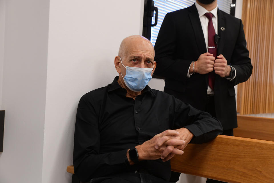 Former Israeli Prime Minister Ehud Olmert sits in the Tel Aviv Magistrate's Court Monday, Jan. 10, 2022, during a preliminary hearing in a defamation lawsuit. Former Prime Minister Benjamin Netanyahu, his wife and son appeared in the Tel Aviv Magistrate’s court Monday for the opening of their case against Olmert, Netanyahu’s predecessor as Israel’s prime minister. The Netanyahus are suing Olmert for saying they suffered from “mental illness” during an interview last year. (Avshalom Sassoni/Pool Photo via AP)