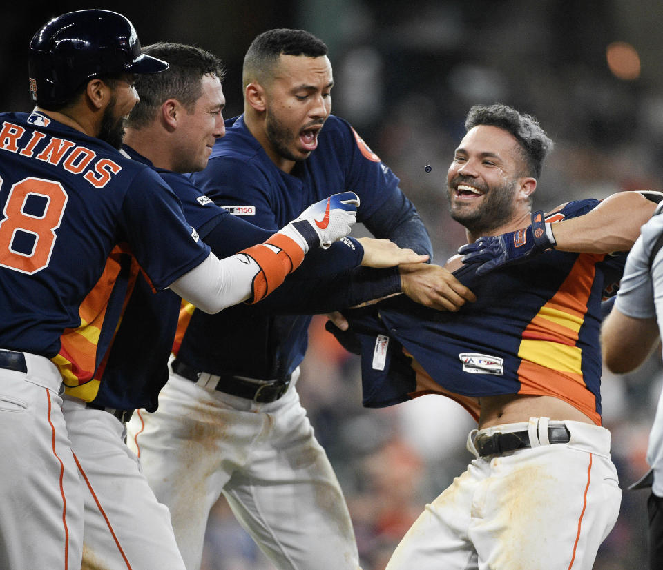 Houston Astros' Jose Altuve, right, celebrates his walk with the bases loaded to win the game during the ninth inning of a baseball game against the Oakland Athletics, Sunday, April 7, 2019, in Houston. (AP Photo/Eric Christian Smith)