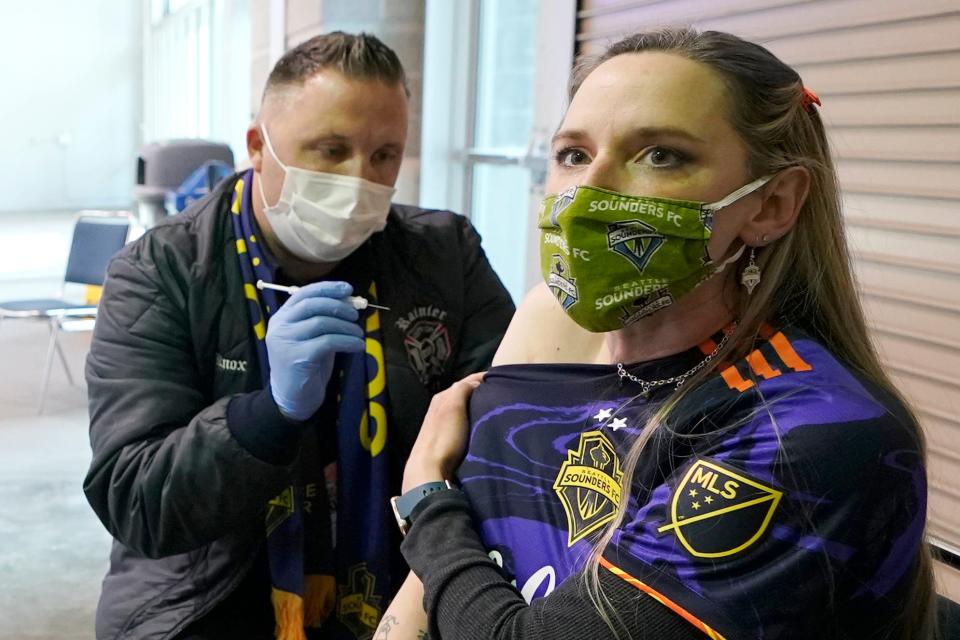 Stephanie Birman, a Seattle Sounders season ticket holder, gets the Johnson & Johnson COVID-19 vaccine at a clinic in a concourse at Lumen Field prior to an MLS soccer match between the Sounders and the Los Angeles Galaxy on May 2.