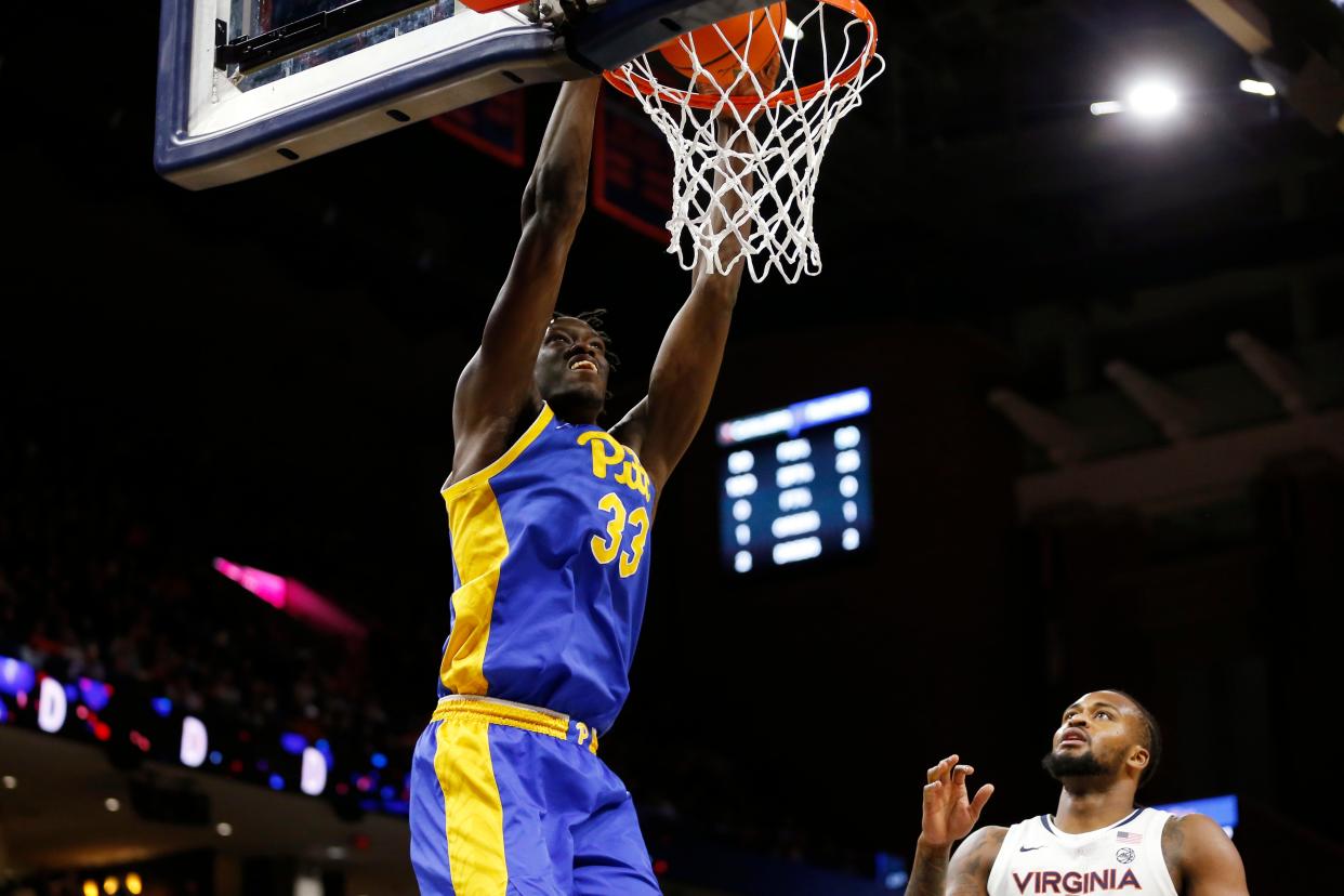 Pittsburgh Panthers center Federiko Federiko (33) dunks the ball past Virginia Cavaliers forward Jordan Minor (22) during the first half at John Paul Jones Arena.