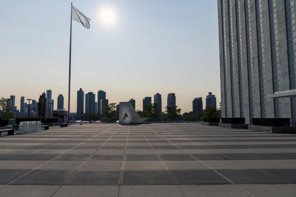 The United Nations flag flies over the empty courtyard at the main entrance to the United Nations headquarters, Monday, Sept. 21, 2020. Born out of World War II’s devastation to save succeeding generations from the scourge of conflict, the United Nations officially marked its 75th anniversary Monday with an appeal from Secretary-General Antonio Guterres to preserve the longest period in modern history without a military confrontation between the world’s most powerful nations. His appeal came at an inflection point in history, as the United Nations navigates a polarized world facing a pandemic, regional conflicts, a shrinking economy and growing inequality. (AP Photo/Mary Altaffer)