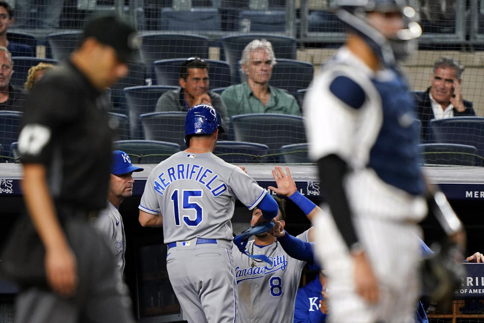 Kansas City Royals Nicky Lopez (8) greets Whit Merrifield (15) at the dugout steps after Merrifield scored on Rynes O'Hearn's RBI infield single during the ninth inning of a baseball game, Wednesday, June 23, 2021, at Yankee Stadium in New York. The Yankees came back to win the game 6-5 in the bottom fo the ninth inning. (AP Photo/Kathy Willens)