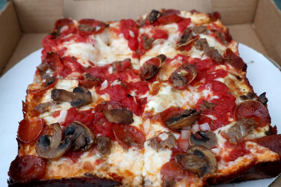 The thick crust Detroit pizza at Squirrel's Pizza is rectangular in shape and cut into 4 slices.