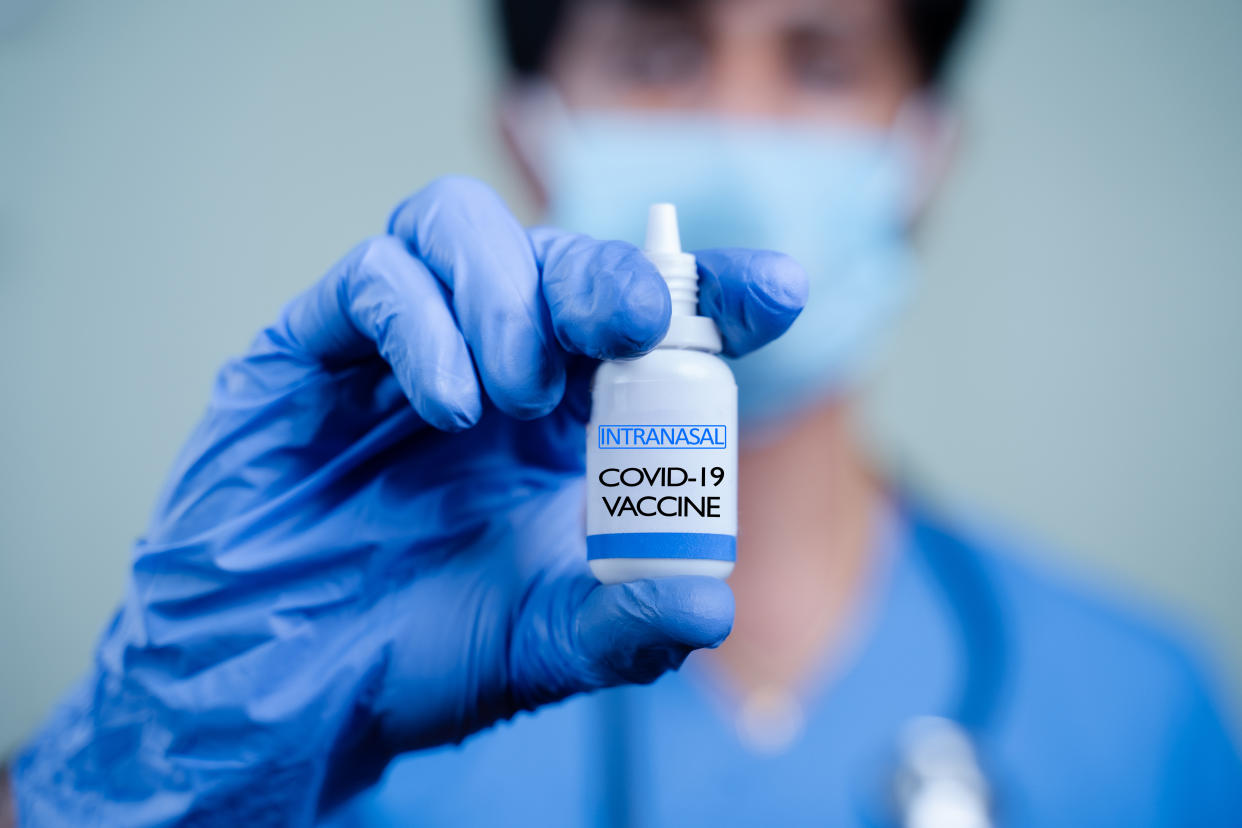Doctor holding nasal vaccine spray bottle for COVID-19. (Getty Images)