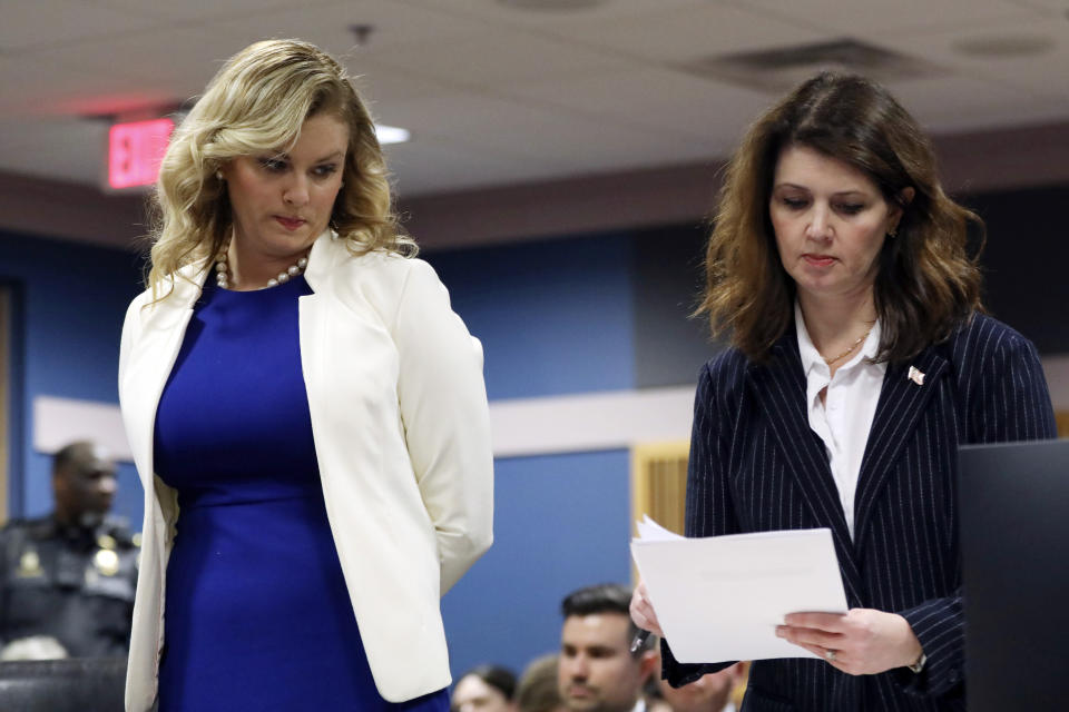 Ashleigh Merchant, left, attorney for Michael Roman, looks on next to attorney Anna Cross, who is representing the Fulton County District Attorney's office, during a hearing on the Georgia election interference case, Thursday, Feb. 15, 2024, in Atlanta. The hearing is to determine whether Fulton County District Attorney Fani Willis should be removed from the case because of a relationship with Nathan Wade, special prosecutor she hired in the election interference case against former President Donald Trump. (Alyssa Pointer/Pool Photo via AP)