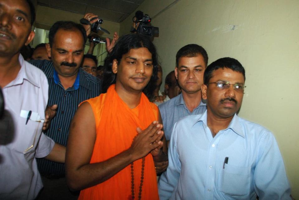 <div class="inline-image__caption"><p>Swami Paramhamsa Nityananda is taken into custody in 2010. </p></div> <div class="inline-image__credit">STR/AFP via Getty</div>