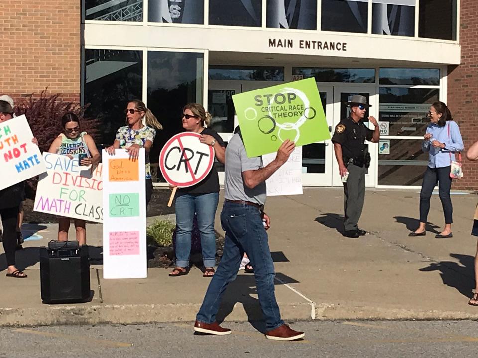 People gathered Monday outside Nagel Middle School with signs denouncing critical race theory, and demanding it not be allowed in teachings or staff trainings at Forest Hill School District.