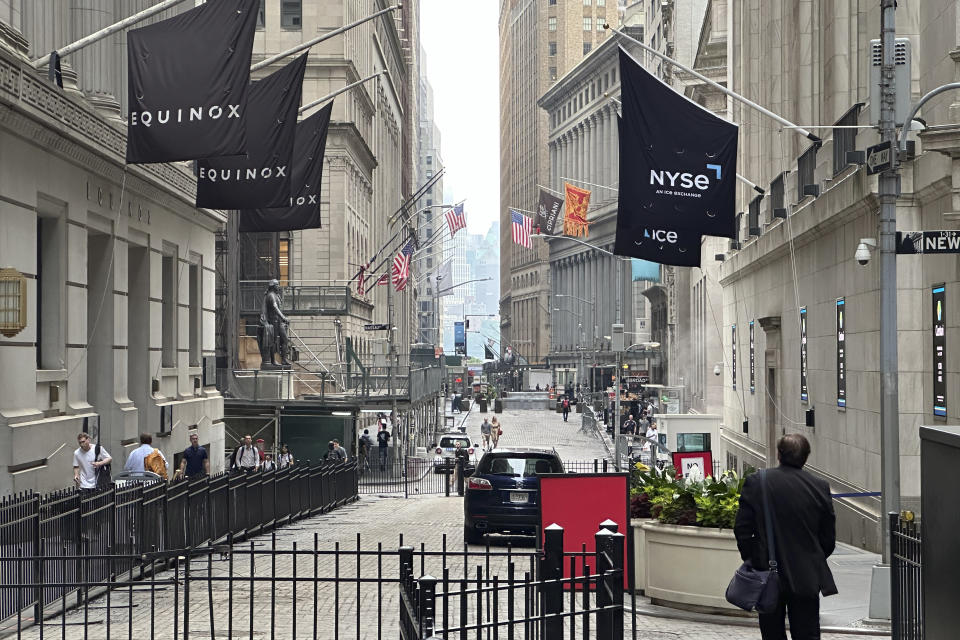 FILE - A man walking on Wall Street approaches the New York Stock Exchange, right, on June 26, 2024, in New York. Shares advanced in Europe on July 1, 2024, with the benchmark in Paris up 2.8% briefly after the far-right National Rally gained a strong lead in first-round legislative elections. (AP Photo/Peter Morgan, File)