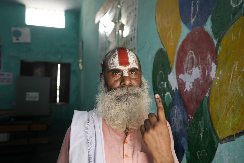 An Indian Hindu holy man shows his finger marked with indelible ink after casting his vote during the fifth round of multi-phase national elections outside a polling station in Ayodhya, India, Monday, May 20, 2024. (AP Photo/Rajesh Kumar Singh)