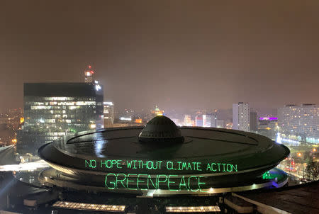 Greenpeace environmental activists project words "No hope without climate action" on the roof of the venue of the COP24 UN Climate Change Conference 2018 in Katowice, Poland December 9, 2018