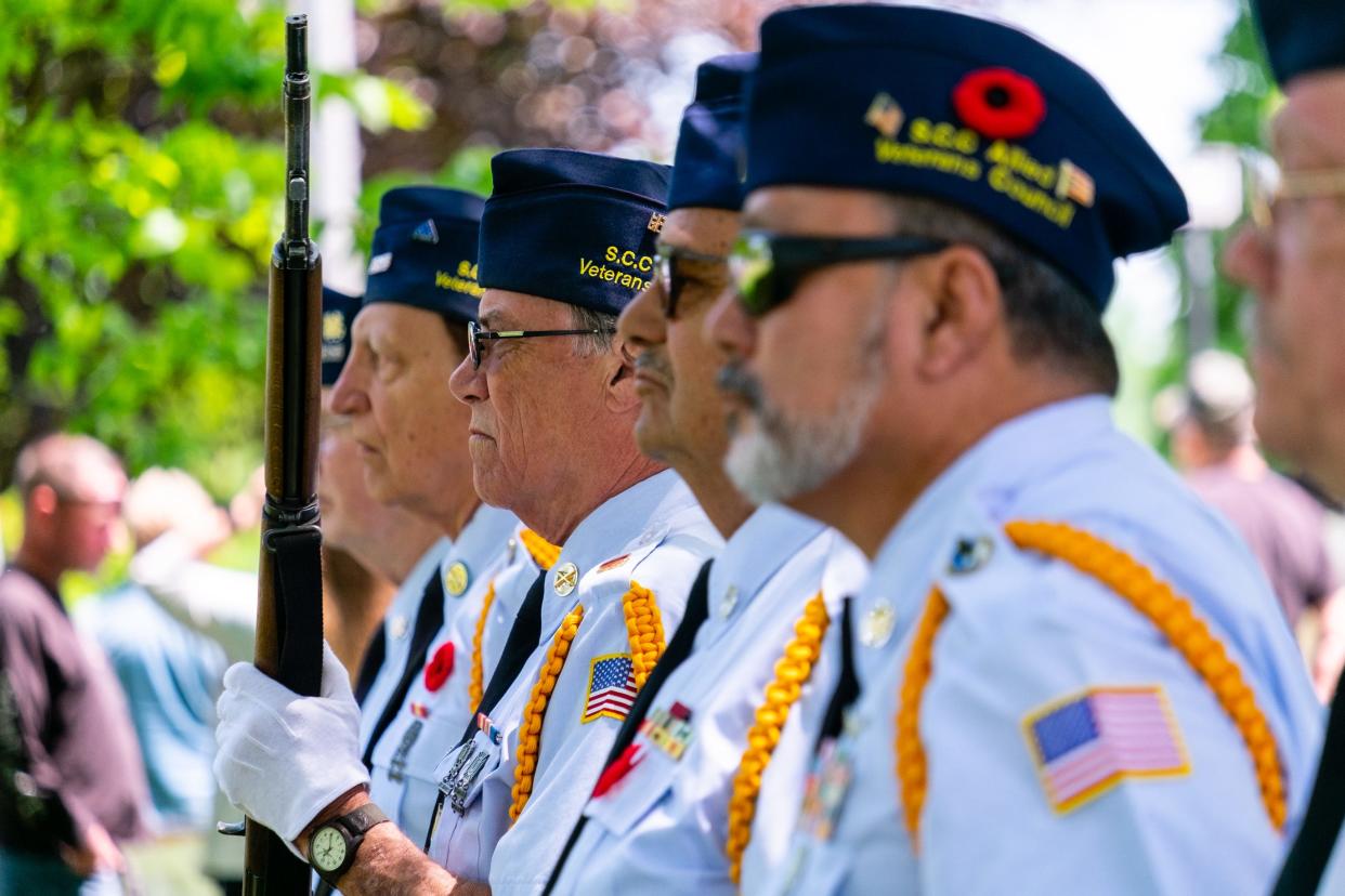 Members of the St. Clair County Allied Veterans Honor Guard stand at attention at a Memorial Day service Monday, May 31, 2021, at Pine Grove Park in Port Huron.