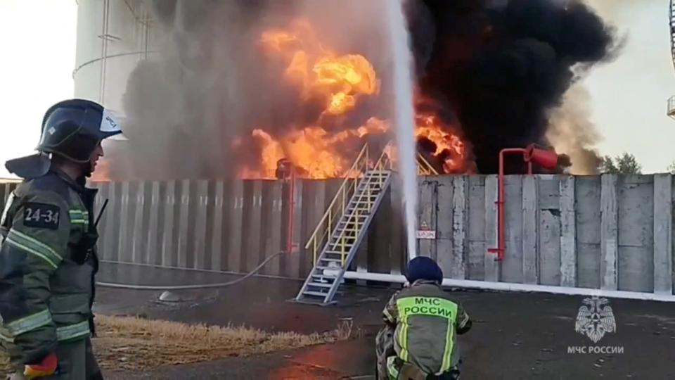 Members of the Russian emergencies ministry work to extinguish fire at an oil storage tank after an alleged drone attack in the town of Azov in the southern region of Rostov, Russia (via REUTERS)