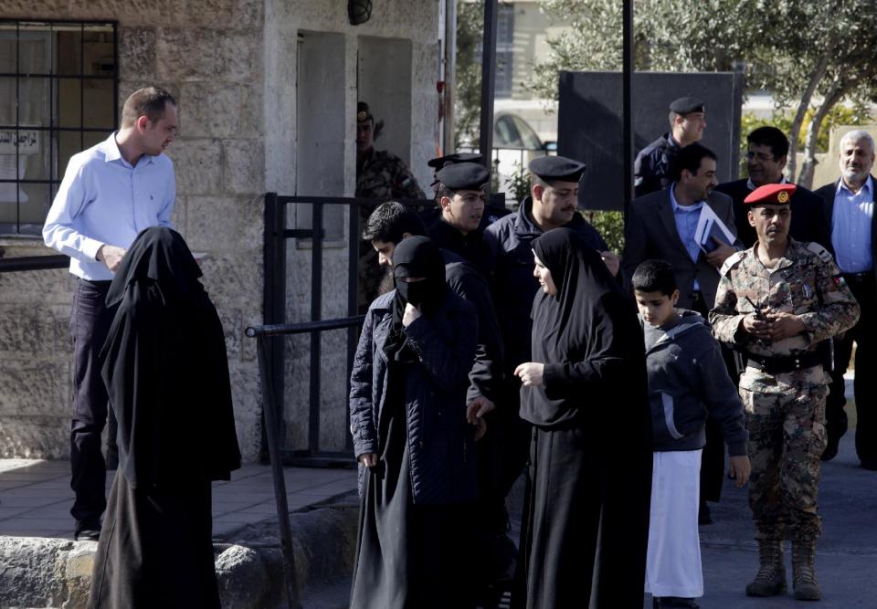 The relatives of radical Sunni preacher, Abu Qatada, leave the Jordanian military court, in Amman, Jordan, Thursday, Feb. 13, 2014. The 52-year-old Abu Qatada told reporters during a break in his trial on Thursday that he "supports" suicide attacks in Lebanon against Shiite targets. Abu Qatada has been described as a senior al-Qaida figure in Europe who had close ties to the late Osama bin Laden. (AP Photo/Mohammad Hannon)