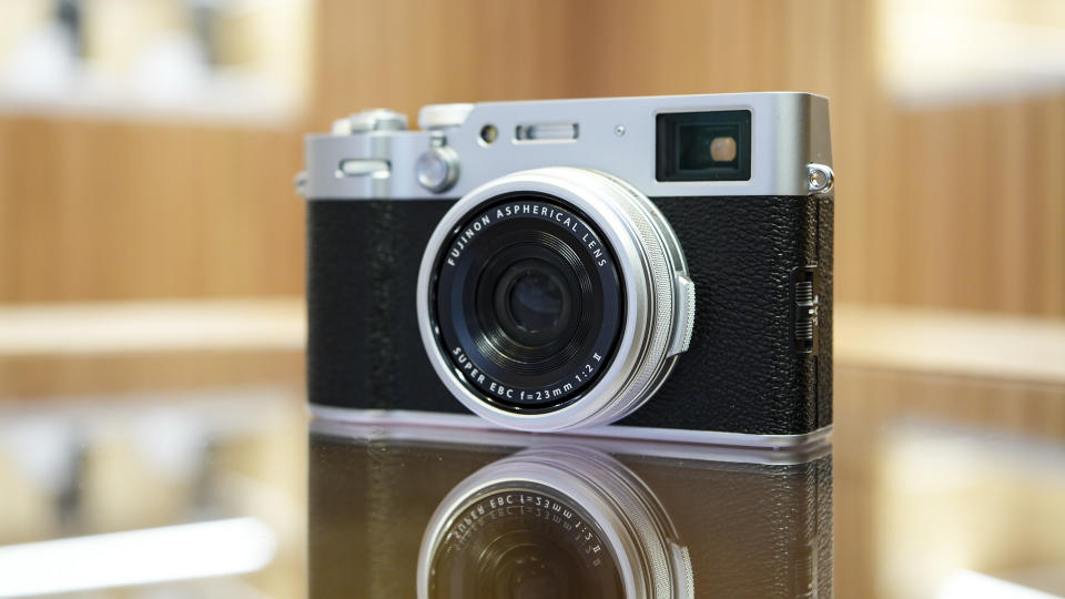 Front of the Fujifilm X100VI reflected in glass table