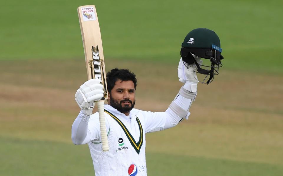 Pakistan's captain Azhar Ali raises his bat and helmet to celebrate scoring a century during the third day of the third cricket Test match between England and Pakistan, at the Ageas Bowl in Southampton, England, Sunday, Aug. 23, 2020. - AP