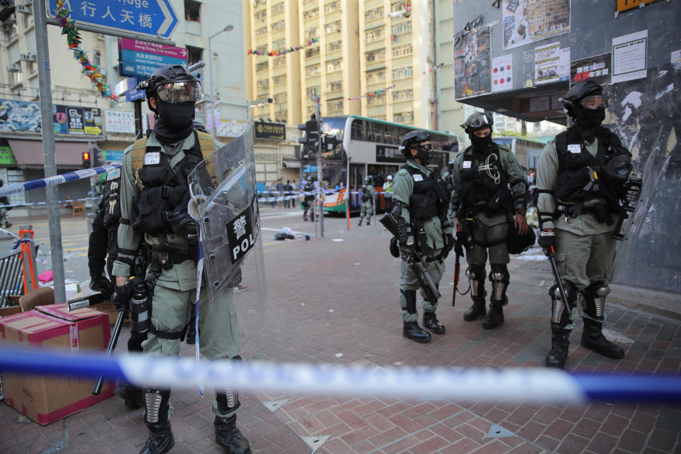 Police cordons off the scene of a morning shooting in Hong Kong Monday, Nov. 11, 2019. Police in Hong Kong were filmed shooting at least one protester and possibly a second on Monday as demonstrators blocked subway lines and roads during the morning commute. (AP Photo/Kin Cheung)