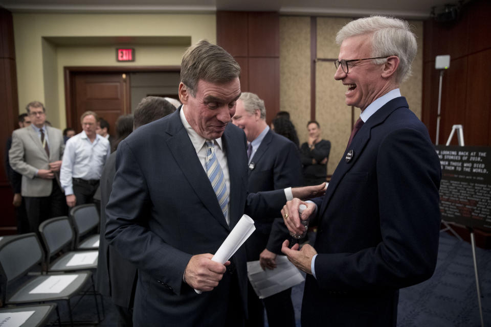 Sen. Mark Warner, D-Va., left, speaks with Washington Post Publisher Fred Ryan, right, at an event marking 100 days since the death of Jamal Khashoggi on Capitol Hill in Washington, Thursday, Jan. 10, 2019. Amnesty International on Thursday renewed a call for an international investigation into the killing of Washington Post columnist Jamal Khashoggi.(AP Photo/Andrew Harnik)
