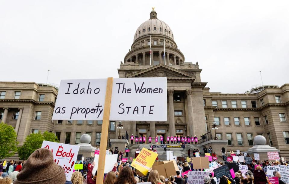 An attendee at Planned Parenthood’s Bans Off Our Bodies rally for abortion rights holds a sign reading “Idaho the women as property state” outside of the Idaho Statehous in May 2022.