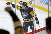 Pittsburgh Penguins' Jared McCann (19) celebrates a goal against the New York Islanders along with fans during the first period of an NHL hockey game, Monday, March 29, 2021, in Pittsburgh. (AP Photo/Keith Srakocic)