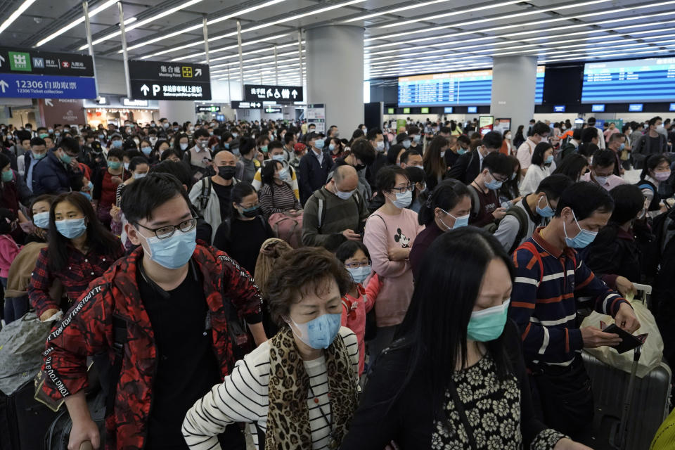 Passengers wear protective face masks at the departure hall of the high speed train station in Hong Kong, Thursday, Jan. 23, 2020. China closed off a city of more than 11 million people Thursday, halting transportation and warning against public gatherings, to try to stop the spread of a deadly new virus that has sickened hundreds and spread to other cities and countries in the Lunar New Year travel rush. (AP Photo/Kin Cheung)