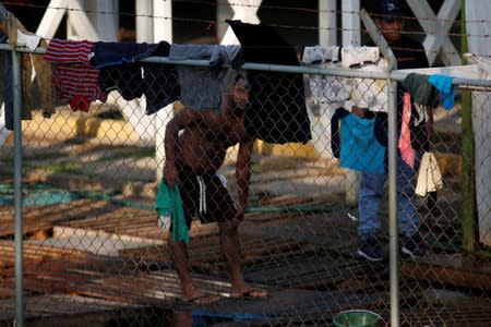 Central American migrants clean themselves in an immigration facility in Ciudad Hidalgo