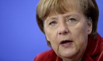 German Chancellor Angela Merkel addresses the media during a joint press conference with the President of Poland, Donald Tusk, after a meeting at the chancellery in Berlin, Germany, Friday, Jan. 31, 2014. (AP Photo/Michael Sohn)