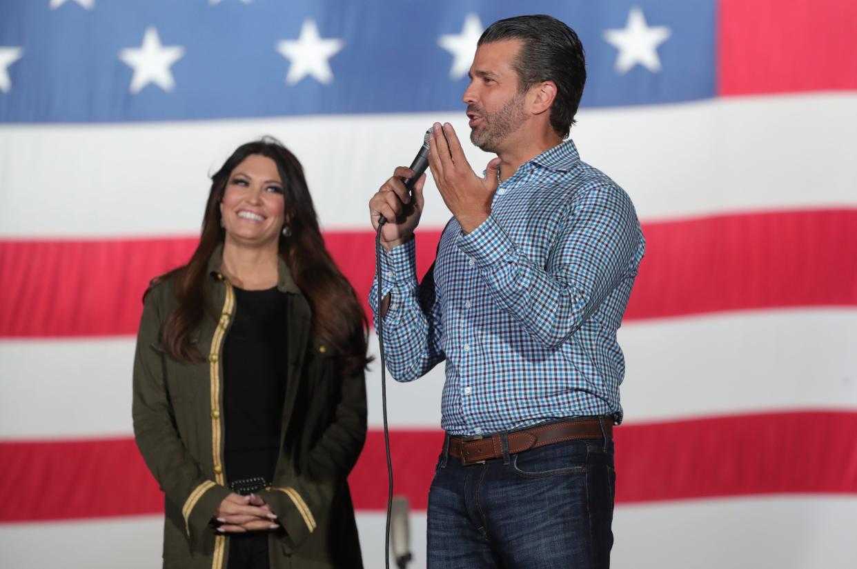 Donald Trump Jr., with girlfriend Kimberly Guilfoyle, speaks to a crowd during a Michigan rally for his father, Donald Trump, on Sept. 14.