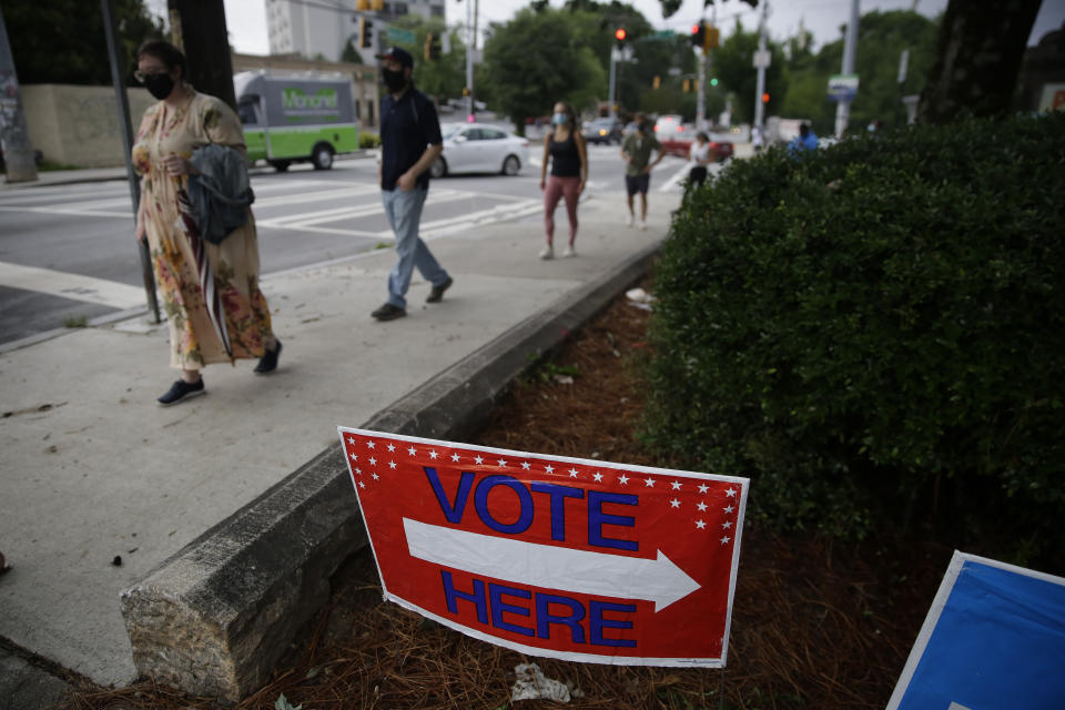 People wait in a line to vote in the Georgia's primary election at Park Tavern on Tuesday, June 9, 2020, in Atlanta. (AP Photo/Brynn Anderson)