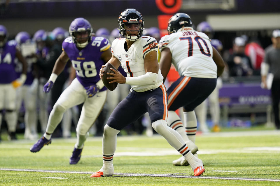 Chicago Bears quarterback Justin Fields (1) looks to pass during the first half of an NFL football game against the Minnesota Vikings, Sunday, Oct. 9, 2022, in Minneapolis. (AP Photo/Abbie Parr)