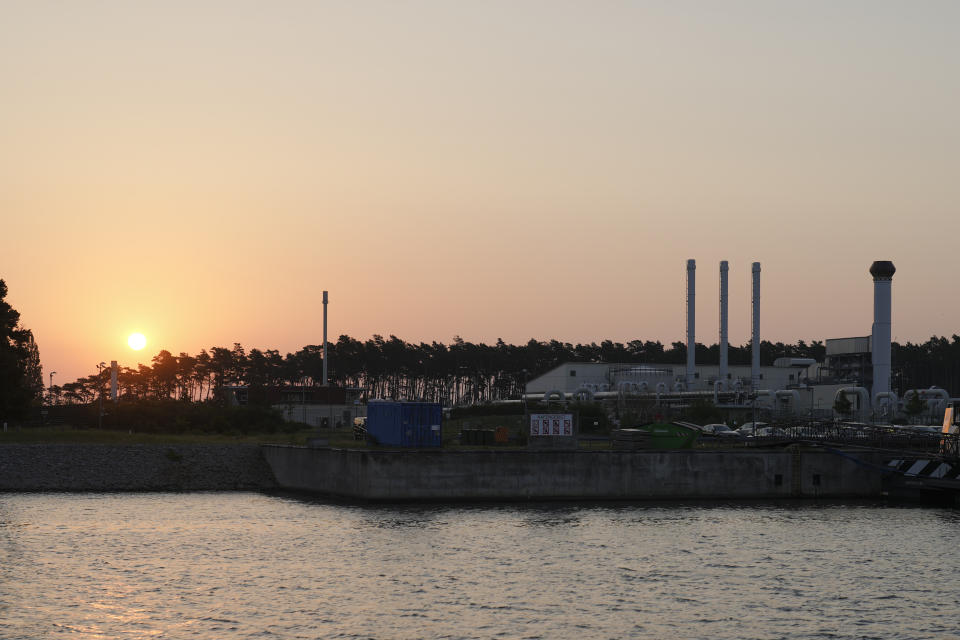 The sun rises behind the landfall of the Nord Stream 1 Baltic Sea pipeline and the transfer station of the OPAL gas pipeline, the Baltic Sea Pipeline Link, in Lubmin, Germany, Thursday, July 21, 2022. (AP Photo/Markus Schreiber)