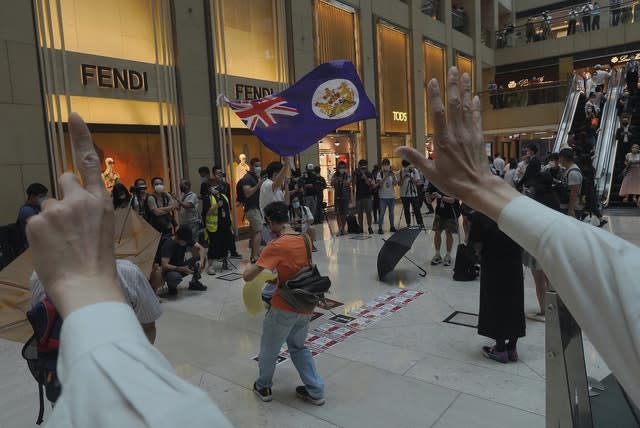 Protesters wave a Hong Kong colonial flag (VIncent Yu/AP)