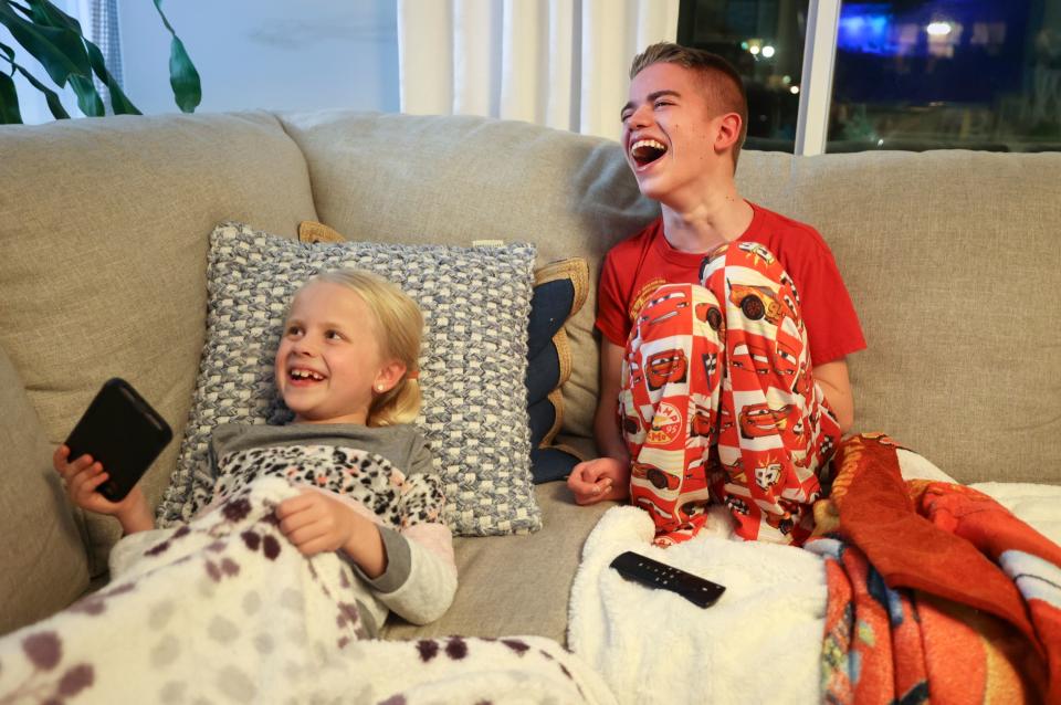 Chloe Sintz, 8, and her brother Isaac Sintz, 16, laugh while relaxing at home in South Jordan on Wednesday, March 22, 2023. Isaac, 16, has Dravet Syndrome, a severe form of epilepsy, and uses cannabidiol to treat his seizures. | Kristin Murphy, Deseret News