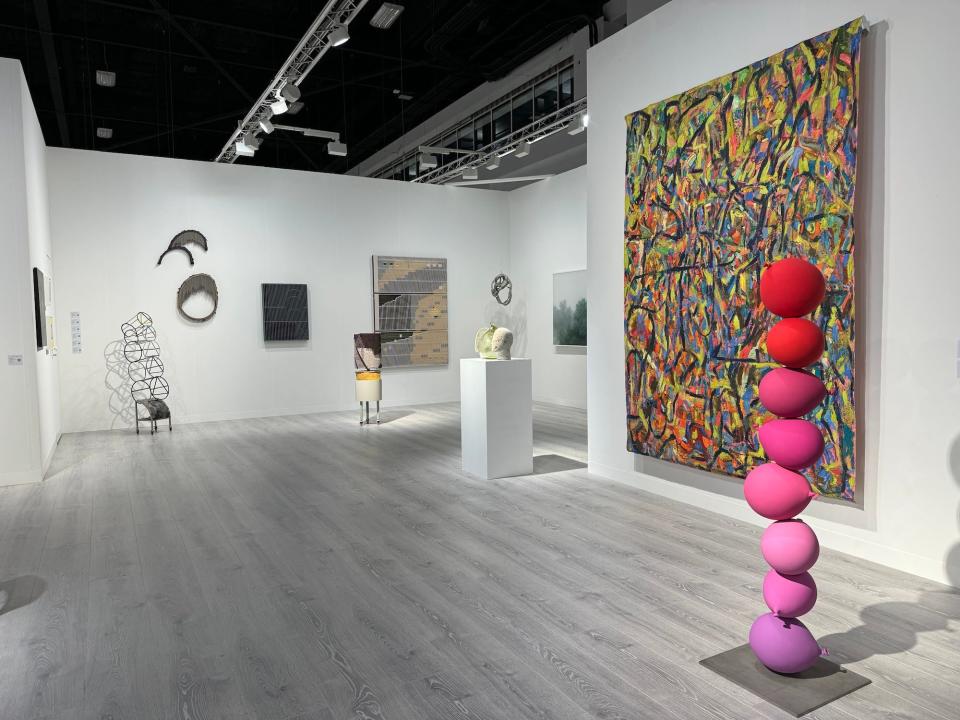 Sculptures and paintings in a gallery.