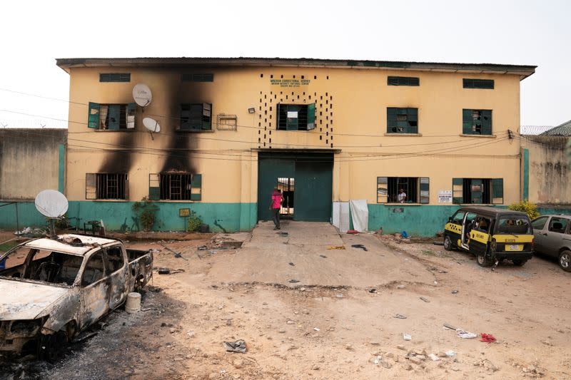 A man is seen standing in front of the main gate of the Nigerian Correctional Services facility that was attacked by gunmen, with large numbers of inmates set freed afterwards in Imo State