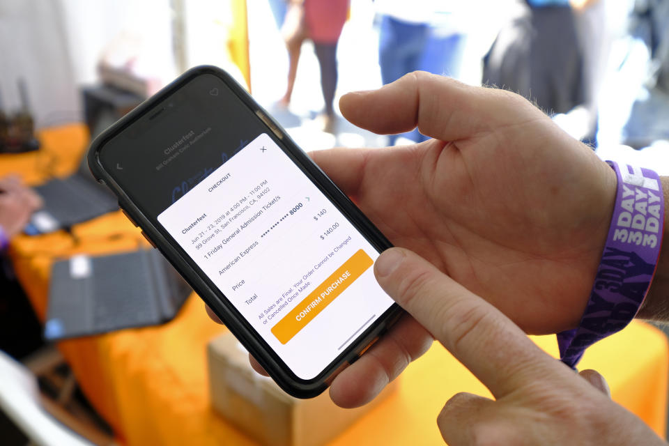 In this photo taken Friday, June 21, 2019, FlipTix CEO Jaime Siegel demonstrates his company's application at the Clusterfest comedy event in San Francisco. The company's application lets people who leave a venue early sell their ticket and lets someone who wants the remainder of the ticket buy it. (AP Photo/Eric Risberg)