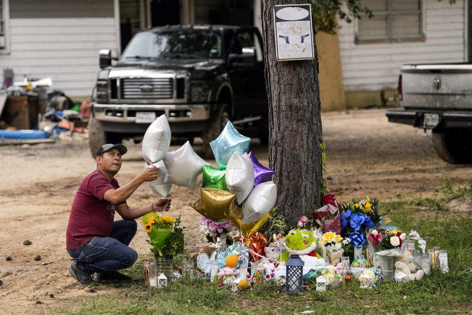 A man releases a balloon from the makeshift memorial outside the victims' home on May 2, 2023, in Cleveland, Texas. (David J. Phillip / AP)