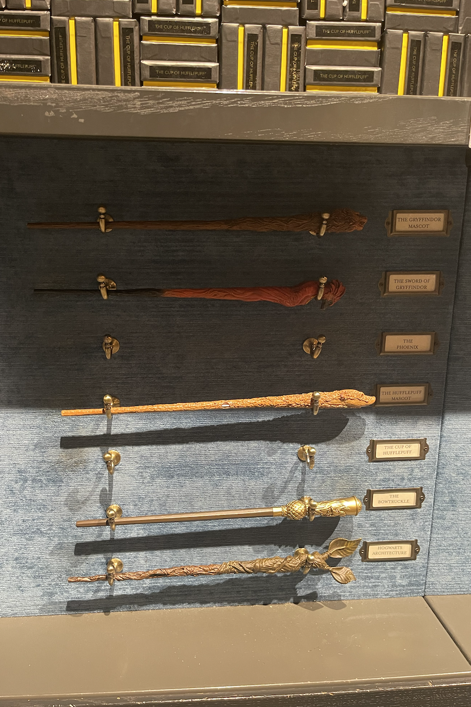 Display of various wands from the Harry Potter series with nameplates for each character's wand