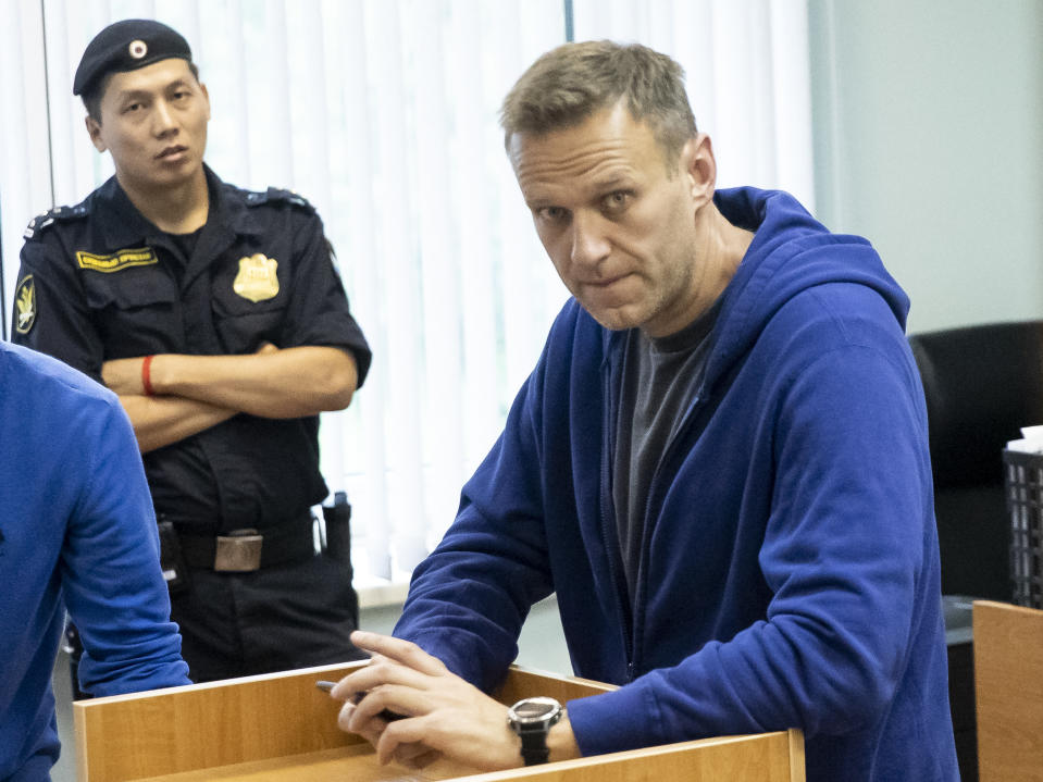 Alexei Navalny, Russia's most prominent opposition figure, who has been detained by police and charged with unlawfully organizing a public gathering, sits in a court room in Moscow, Russia, Wednesday, July 24, 2019. Navalny has called for demonstrators to protest on Saturday outside the mayor's office against the rejection of several opposition candidates from the ballot for the Moscow city council elections. (AP Photo/Pavel Golovkin)