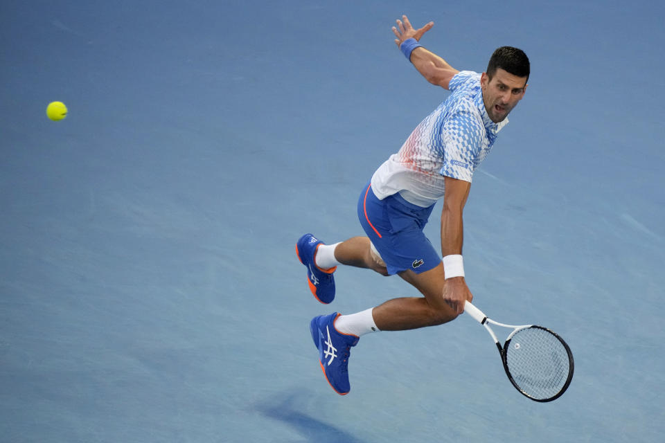 Novak Djokovic of Serbia plays a backhand return to Tommy Paul of the U.S. during their semifinal at the Australian Open tennis championship in Melbourne, Australia, Friday, Jan. 27, 2023. (AP Photo/Dita Alangkara)