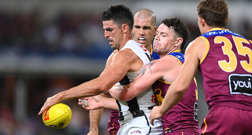 Pictured here, Collingwood's Scott Pendlbury being tackled Lachie Neale.