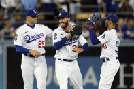 Los Angeles Dodgers' Trayce Thompson (25) Cody Bellinger, center, and Mookie Betts celebrate a 6-4 win over the Colorado Rockies during a baseball game Saturday, Oct. 1, 2022, in Los Angeles. (AP Photo/Marcio Jose Sanchez)