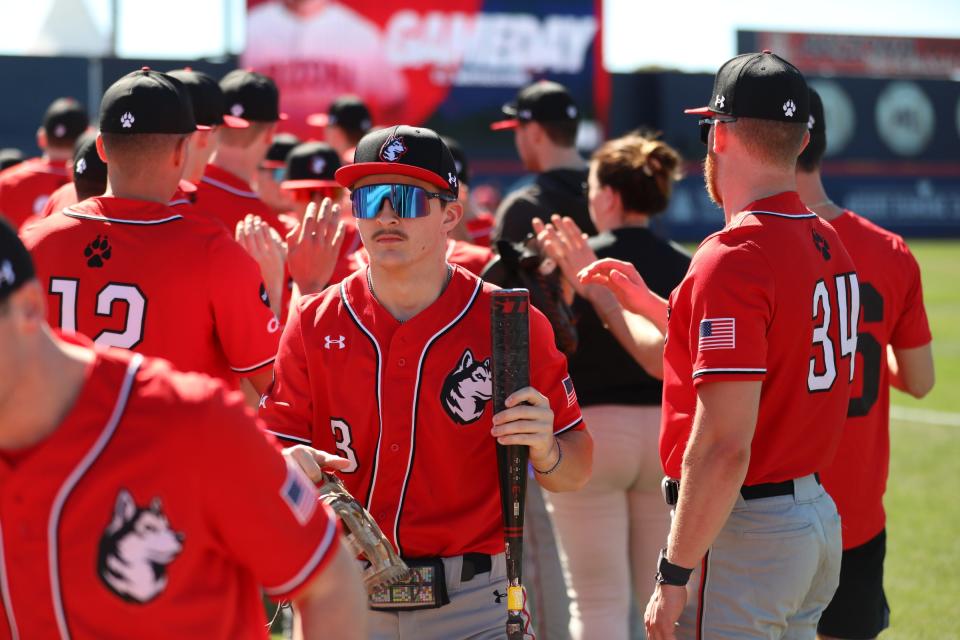 Northeastern freshman Ryan Gerety of Franklin high fives his teammates during the team's early season spring trip to Floriday.