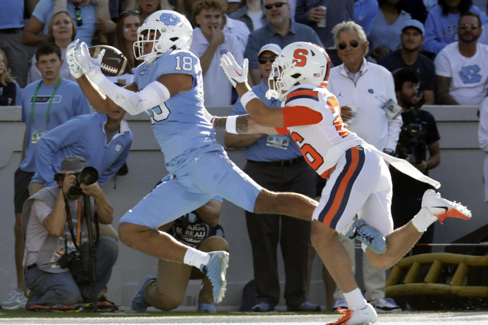 North Carolina tight end Bryson Nesbit (18) pulls in a touchdown pass against Syracuse defensive back Aman Greenwood (26) during the first half of an NCAA college football game Saturday, Oct. 7, 2023, in Chapel Hill, N.C. (AP Photo/Chris Seward)