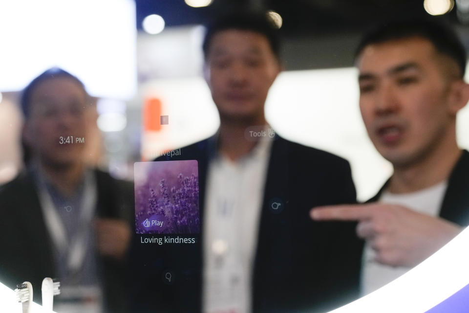 An exhibitor provides a demonstration of Baracoda's BMind smart mirror during the CES tech show Wednesday, Jan. 10, 2024, in Las Vegas. The mirror is intended to help users with mental health and can be interacted with using voice commands, gestures, and "intent detection". (AP Photo/Ryan Sun)