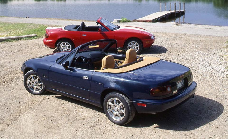 <p>In a bid to enhance the Miata's safety, Mazda adds a cross-body brace behind the seats, anti-intrusion beams in the doors, and a passenger-side airbag to the roadster. The engine also gets a big upgrade from the original Miata's 1.6-liter to a new 1.8-liter four-banger making 128 horsepower (a ten-percent bump). Larger brake rotors are also part of the deal, and the optional limited-slip differential goes from a viscous unit to a more durable Torsen diff. Mazda also ditches the "Mazda" sticker on the Miata's front bumper in favor of its then-new corporate badge, which is affixed to the sports car's nose. It is affectionately known as the "toilet-bowl badge," given its resemblance to, well, the inside of a toilet bowl as viewed from above.<br></p>