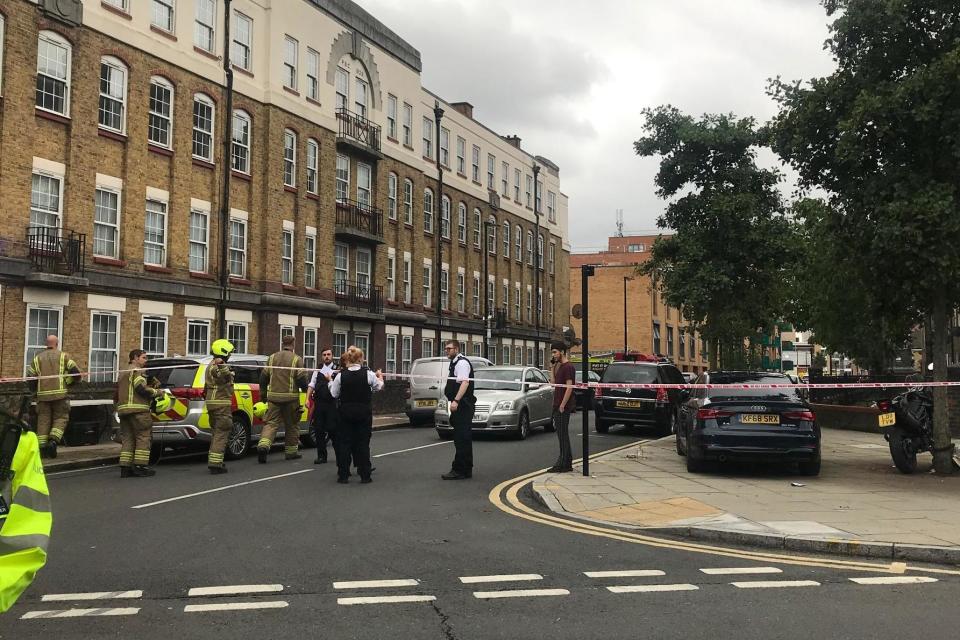 Firefighters and police officers at the scene in Bow, east London (Rachael Burford)